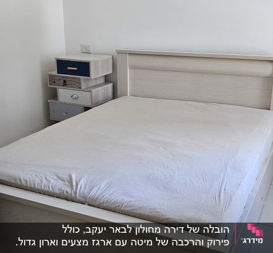 מיטה וחדר שינה עם שידה קטנה